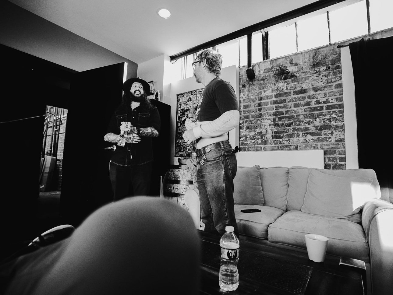Black and white photo of Shawn James talking backstage with Trappers Pass